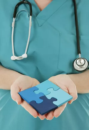 Nurse_Holding_Assembled_Puzzle_Pieces